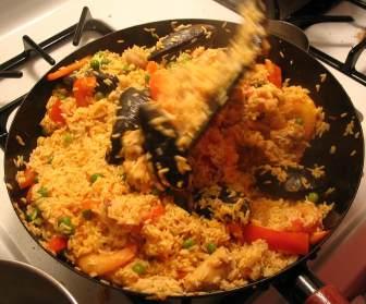 Preparing Paella: This example contains peas, chicken, shellfish and calamari